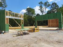 Home construction site featuring wall framing and ZIP system sheathing on a sunny day at 8916 Thompson Mill Rd, Wake Forest, NC 27587
