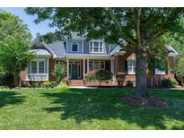 Charming brick home with manicured lawn and mature trees, offering great curb appeal at 9048 Chelsea Dr, Raleigh, NC 27603