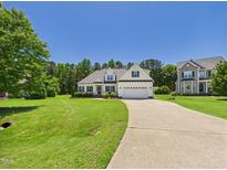 Charming single-Gathering home with a manicured front lawn and inviting driveway at 100 S Sunset Ridge Dr, Willow Springs, NC 27592