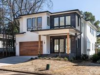 Striking modern two-story home featuring a mix of white siding and dark brick accents at 1009 Parker St, Raleigh, NC 27607