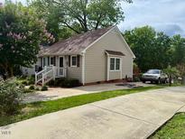 Charming home with well-maintained lawn, mature trees, and long driveway at 120 W Front St, Oxford, NC 27565