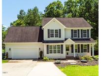 Charming two-story home with a two-car garage, well-maintained lawn, and mature trees at 1201 Teakwood Ct, Sanford, NC 27330