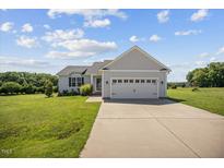 Charming single-Gathering home with well-manicured lawn and attached two-car garage at 174 Arrow Ln, Middlesex, NC 27557