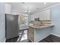 Bright kitchen features granite countertops, stainless appliances, and a large window at 2106 White Pond Ct, Apex, NC 27523