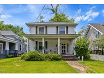 Charming two-story home featuring a welcoming front porch with classic columns at 218 Villa St, Rocky Mount, NC 27804