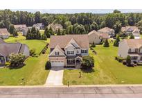 Beautiful home with well-manicured lawn, mature trees, and fenced backyard in established neighborhood at 265 Beckwith Ave, Clayton, NC 27527