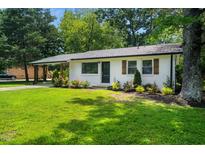 Charming brick home with a well-maintained lawn and mature trees, showcasing its inviting curb appeal at 313 13Th St, Butner, NC 27509