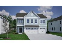 Beautiful two-story home with light blue siding, a three-car garage and a well manicured lawn at 335 Augusta Pond Way # 174, Raleigh, NC 27603