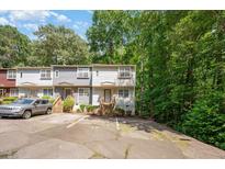 Charming townhome featuring neutral siding, wood stairs, and dedicated parking spaces at 3622 Colchester St # 17, Durham, NC 27707