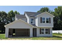 Charming two-story home features a two-car garage, gray siding, black roof, and dark brown window shutters at 3881 Josiah Ct, Nashville, NC 27856