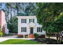 Charming two-story home with black shutters, landscaped front yard, and brick-lined entry at 4416 Lancashire Dr, Raleigh, NC 27613