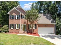 Beautiful two-story brick home with a well-maintained lawn and attached two-car garage at 4733 Royal Troon Dr, Raleigh, NC 27604
