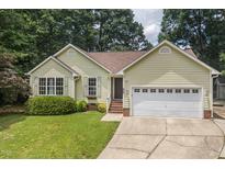 Charming single-story home with a well-manicured lawn, two-car garage and traditional architectural details at 6205 Houndsman Ct, Raleigh, NC 27616