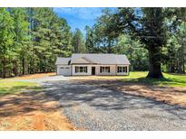 Charming single-story home with a gravel driveway and black shutters at 7082 Cornwall Rd, Oxford, NC 27565