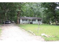 Charming single-story home with a well-maintained lawn and mature trees offering shade at 908 Valmet Dr, Durham, NC 27703