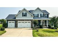Charming two-story home with a well-manicured lawn and three-car garage at 192 Waterpine Dr, Garner, NC 27529