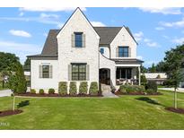 Beautiful white brick home with manicured lawn and professional landscaping at 241 Teague St, Wake Forest, NC 27587