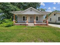 Charming single-story home with a covered porch and a well-maintained lawn at 2927 S Church St, Rocky Mount, NC 27803