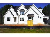 New construction home showcasing a modern white facade, gabled roof and a manicured lawn in a suburban setting at 3004 William Frederick Way, Raleigh, NC 27603