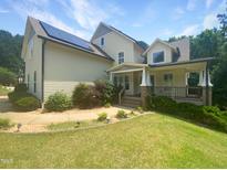 Charming two-story home with solar panels and a covered front porch at 495 Ruth Cir, Fuquay Varina, NC 27526