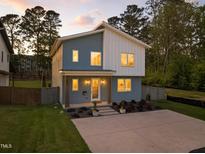 Charming two-story home with a modern design and a well-manicured lawn and a spacious driveway at 505 Colleton Rd, Raleigh, NC 27610