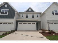 Traditional two-story home with white and blue painted siding and attached two-car garages at 912 Montague Ave, Durham, NC 27703