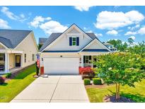 Charming single-story home with a two-car garage, a landscaped front yard, and a welcoming entrance at 1004 Sounding Ln, Durham, NC 27703