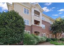 Beautiful multi-level exterior showcasing brick and siding details, complemented by mature landscaping at 108-203 Northbrook Dr # 203, Raleigh, NC 27609