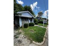 Charming single-story home with stone accents and a well-maintained lawn and shrubbery at 1305 E Jones St, Raleigh, NC 27610
