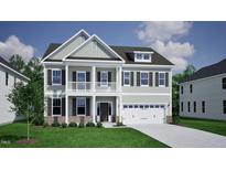Charming two-story home featuring a double front porch, a two-car garage, and manicured landscaping at 221 Savannah Moss Way # 119, Raleigh, NC 27603