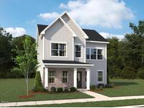 Charming two-story home with vertical siding, a brick-clad porch, and lush landscaping at 2864 Quarry Rd # 168, Rolesville, NC 27571