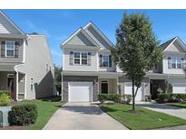 Inviting two-story home featuring a one-car garage, stone accents, and professionally maintained landscaping at 3636 Water Mist Ln, Raleigh, NC 27604