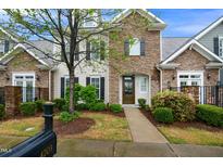 Beautiful townhome with stone accents and a well-maintained front yard with lush greenery at 4203 Overcup Oak Ln, Cary, NC 27519