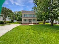 Charming two-story home with a manicured front yard and inviting front porch at 5356 Baywood Forest Dr, Knightdale, NC 27545
