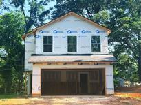This home features a two-car garage, ample windows, and durable exterior materials at 608 Vance St, Mebane, NC 27302