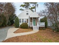 Charming home featuring a quaint front porch and a well-maintained lawn with mature trees at 625 New Road Rd, Raleigh, NC 27608