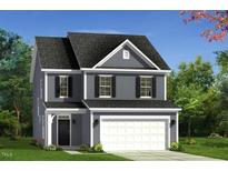 Charming two-story home with a classic design, complemented by a well-maintained lawn and an attached two-car garage at 69 Willow Cameron Way, Angier, NC 27501