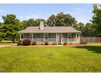 Charming ranch-style home featuring a welcoming front porch, tidy landscaping, and a lush green lawn at 73 Richmond Dr, Archer Lodge, NC 27527