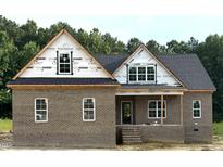 Charming brick home featuring a covered porch and classic design, showcasing quality craftsmanship at 7351 Twin Pines Rd, Spring Hope, NC 27882