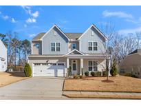 Charming two-story home featuring a two-car garage and beautifully landscaped front yard at 78 N Porcenna Ln, Clayton, NC 27527