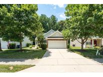 Charming single-Gathering home featuring a two-car garage and mature trees surrounding the property at 7807 Braefield Dr, Raleigh, NC 27616