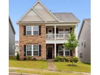 Charming two-story home with a stone facade, covered porch, and well-manicured lawn at 817 James J Freeland Memorial Dr, Hillsborough, NC 27278