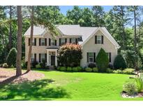 Charming two-story brick home with lush front lawn and mature trees, offering classic curb appeal at 83 Calabria Ct, Clayton, NC 27527