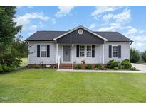 Charming single-story home features a well-manicured lawn and inviting front porch at 11 Sherman Rd, Fuquay Varina, NC 27526