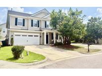 Charming two-story home featuring a well-manicured lawn, two-car garage and inviting front porch at 1121 Brookhill Way, Cary, NC 27519