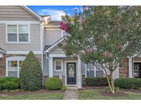 Charming two-story home features a welcoming front porch with stone accents and blooming crape myrtle at 11309 Shadow Elms Lane Ln, Raleigh, NC 27614