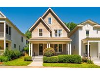 Charming two-story home boasts a welcoming front porch and manicured landscaping, perfect for curb appeal at 1168 Great Ridge Pkwy, Chapel Hill, NC 27516