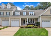 Charming townhome with attached garage, manicured lawn, and covered porch at 1326 Fairview Club Dr, Wake Forest, NC 27587