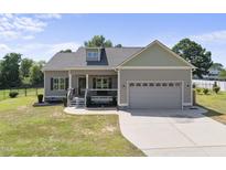 Charming single-Gathering home featuring a two-car garage, covered front porch, and well-maintained lawn at 172 Fox Run Ct, Benson, NC 27504