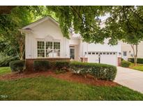 Charming home featuring manicured landscaping, a two-car garage, and a welcoming entrance at 208 Rockport Ridge Way, Cary, NC 27519